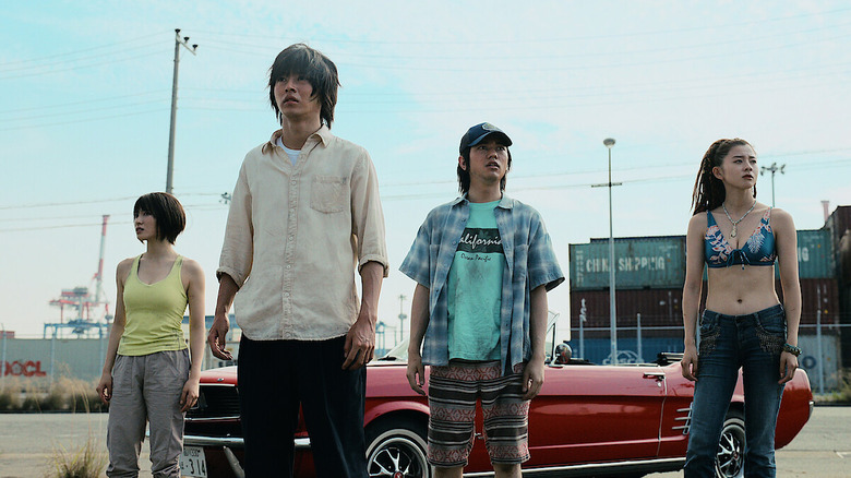 Usagi, Arisu, Niragi, and Kuina standing in front of a red car outside