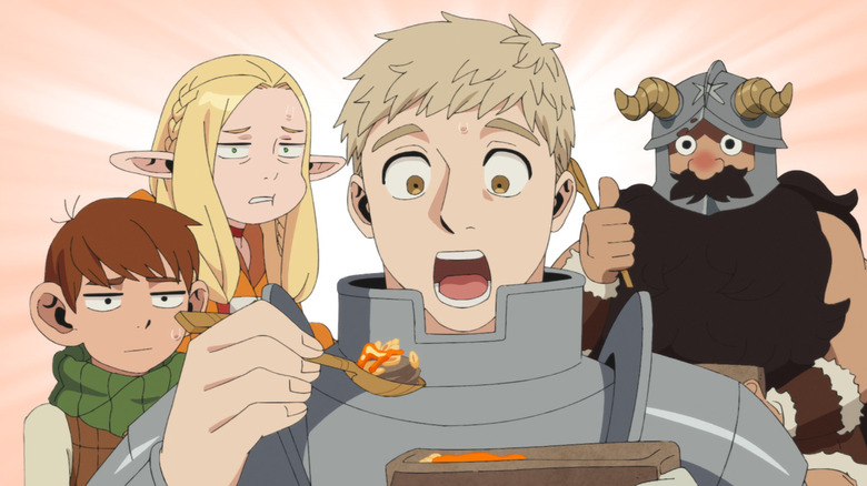 Laios eating a meal while Senshi gives him a thumbs-up and Chilchuck and Marcille look disgusted