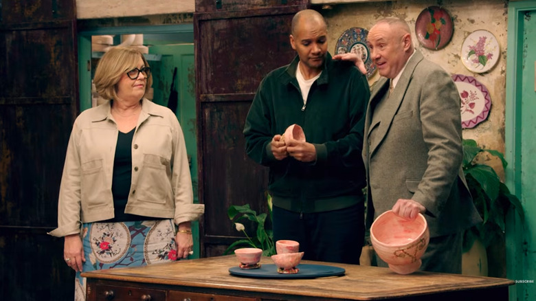 "The Great Pottery Throw Down" contestants standing in front of their ceramics