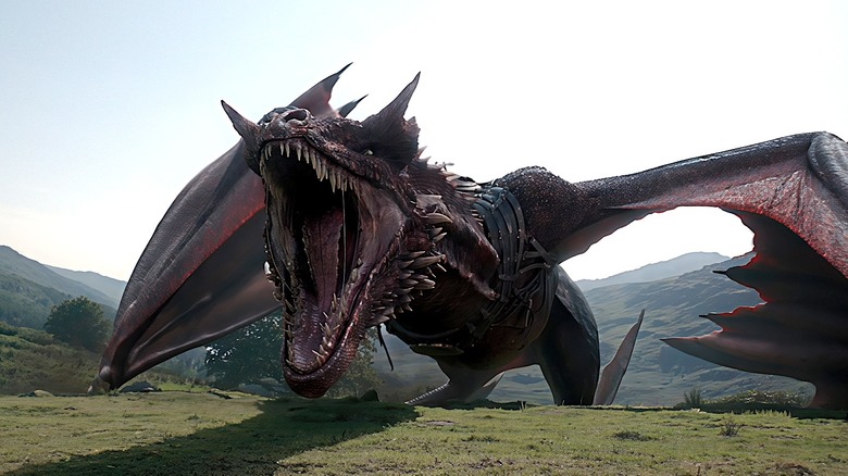Caraxes perched on the ground with his mouth wide open in House of the Dragon