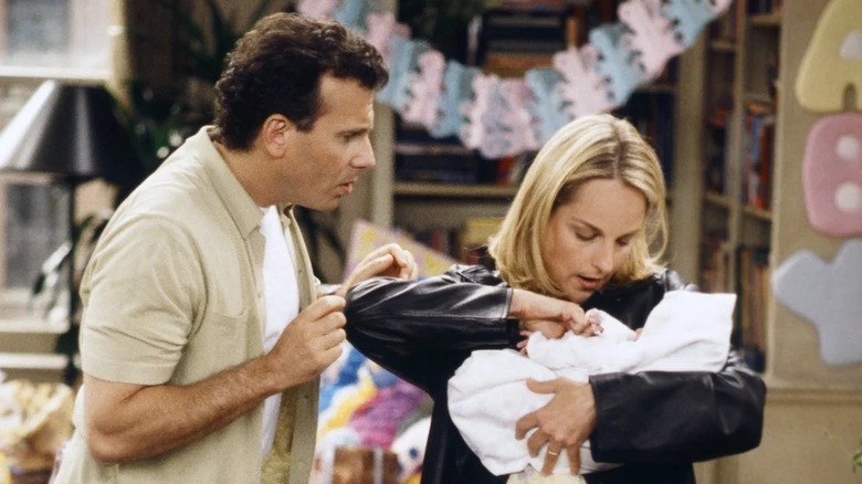 Jamie and Paul fussing over their baby in "Mad About You"