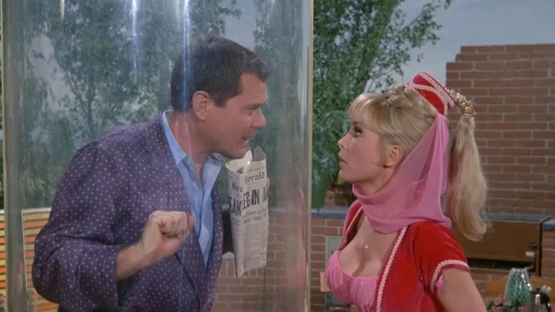 Larry Hagman trapped in plastic cylinder with Barbara Eden as Jeannie next to him in I Dream of Jeannie