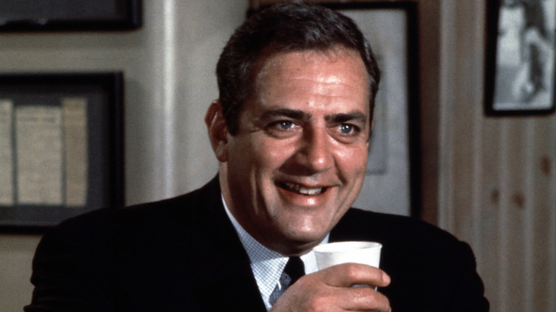 Raymond Burr as Detective Ironside laughing and holding a cup