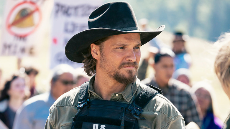 Kayce (Luke Grimes) standing among a crowd on "Marshals."