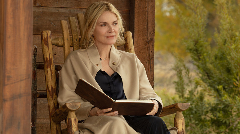 Stacey (Michelle Pfeiffer) sitting in a chair on "The Madison."