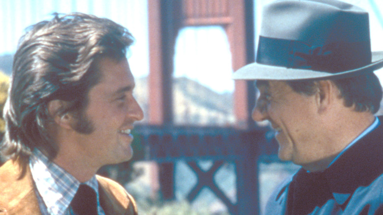 Lt. Mike Stone standing with Inspector Steve Keller with the Golden Gate Bridge in the background in The Streets of San Francisco (1975).