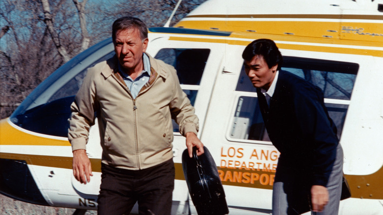 Dr. Quincy and Sam Fujiyama disembark from a helicopter in "Quincy, M.E." (1976)