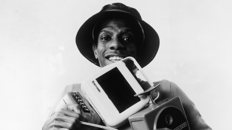 Jimmie Walker posing as J.J. Evans, Jr. from Good Times while holding electronic devices