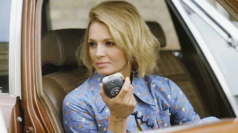 Pepper Anderson sitting in police car holding a radio in "Police Woman" (1974-1978)