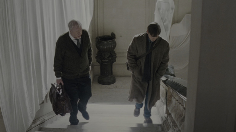 Michael Caine's Alfred Pennyworth and Christian Bale's Bruce Wayne climb the stairs of Wayne Manor in Batman Begins