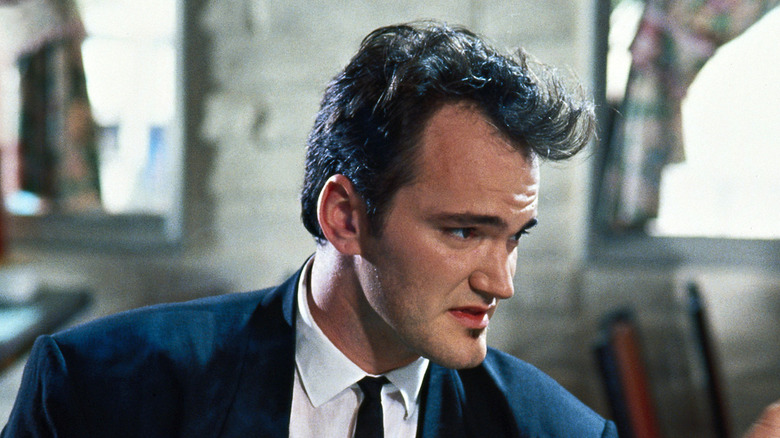 Quentin Tarantino's Mr. Brown sitting down in Reservoir Dogs
