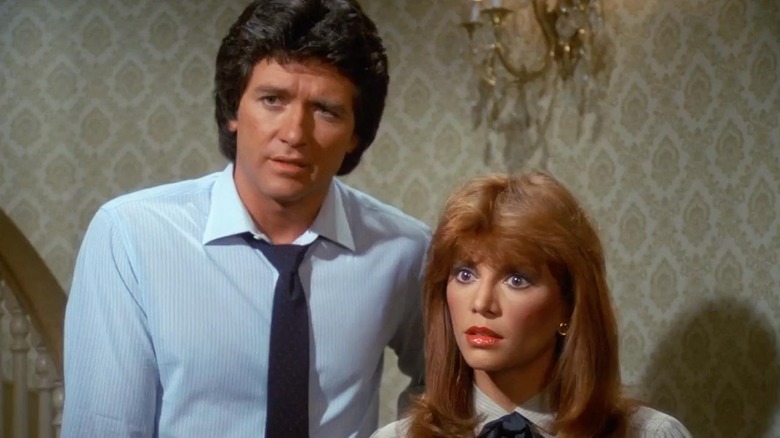 Bobby and Pam Ewing looking off screen at someone with concern in Dallas