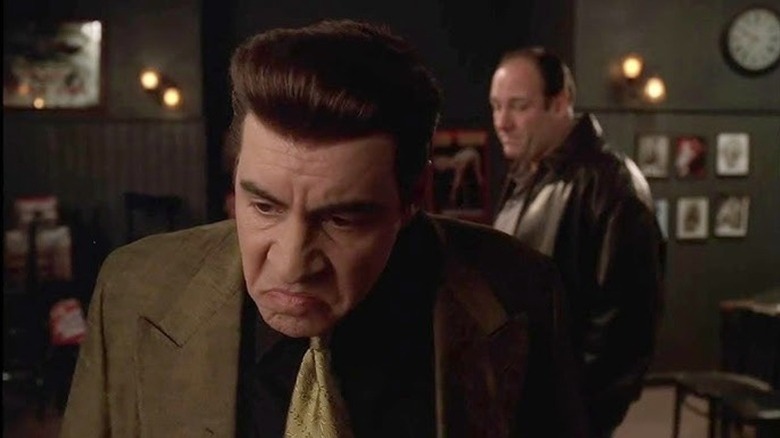 Silvio looking away with Tony hovering in the background in The Sopranos
