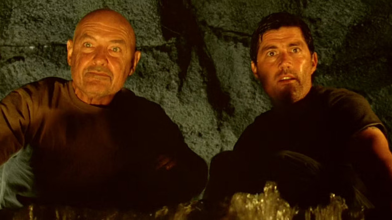 John Locke and Jack Shephard looking down into the heart of the island next to one another