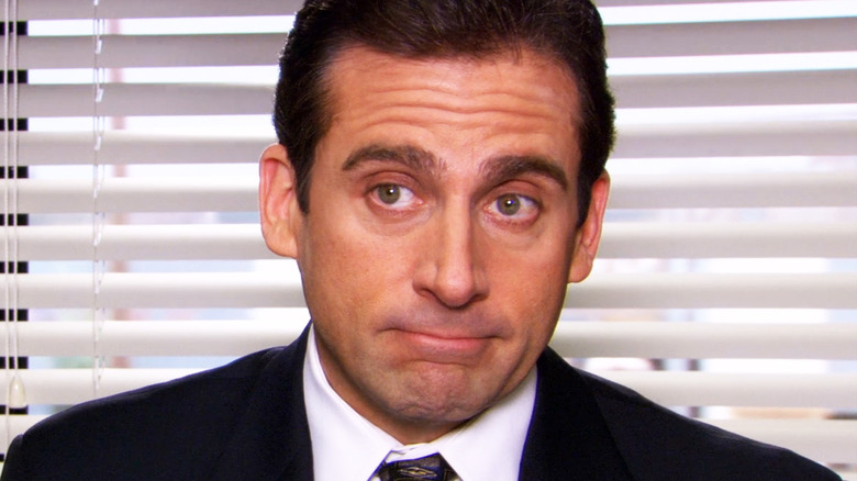Steve Carell's Michael Scott is seen in closeup against a blind in The Office