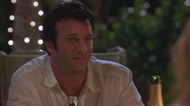 Frank Castle smiles at the dinner table in a pre-vigilante scene of "The Punisher" (2004)