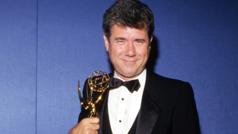 John Larroquette holding a statuette at the Emmys