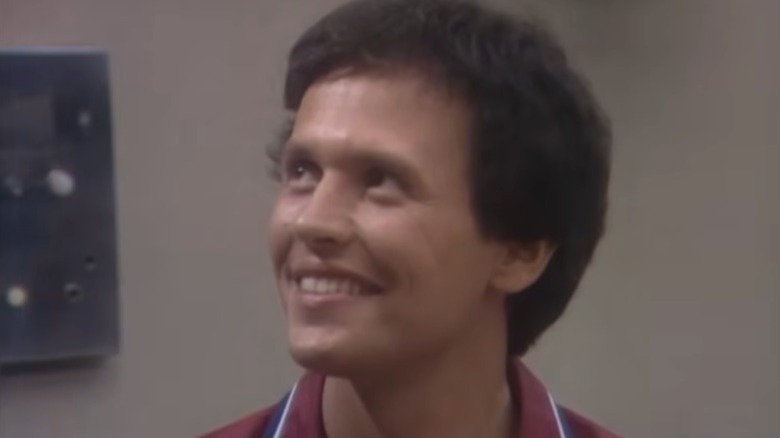 Jodie Dallas, with fluffy hair, grins upward in "Soap"