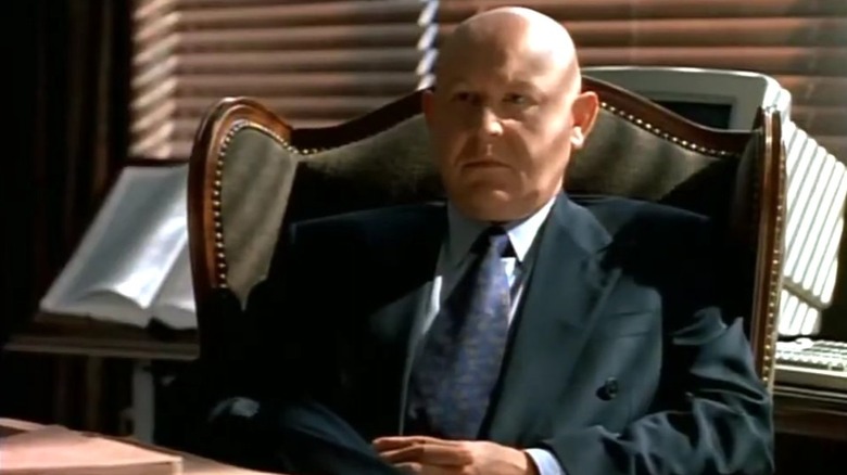 Daniel Benzali as Theodore Hoffman in wingback office chair looking solemn in "Murder One"