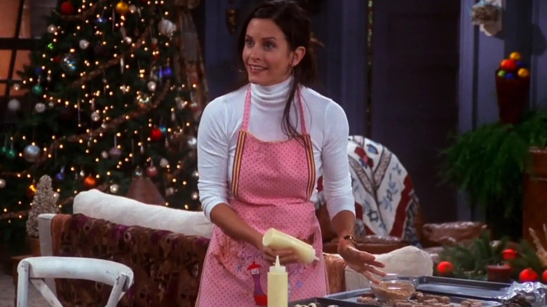 Courtney Cox as Monica, making cookies on Friends.