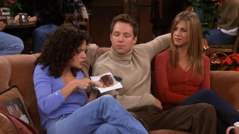 George Newbern, Julie Lauren, and Jennifer Aniston as Danny, Krista, and Rachel, sitting together on Friends.