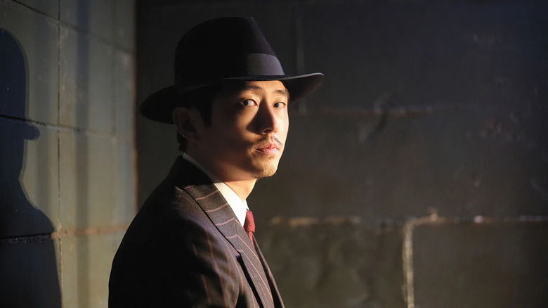 A Traveler (Steven Yeun) sits in a jail cell in The Twilight Zone