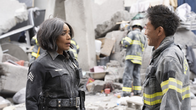 Angela Bassett's Athena Grant-Nash and Kenneth Choi's Howard Han in the ruins of a building on 9-1-1