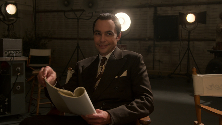 Jim Parsons' Henry Wilson holding a script and smiling on Hollywood