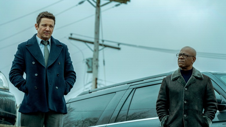 Mike McLusky and Frank Moses stand by a car in "Mayor of Kingstown" (2021)