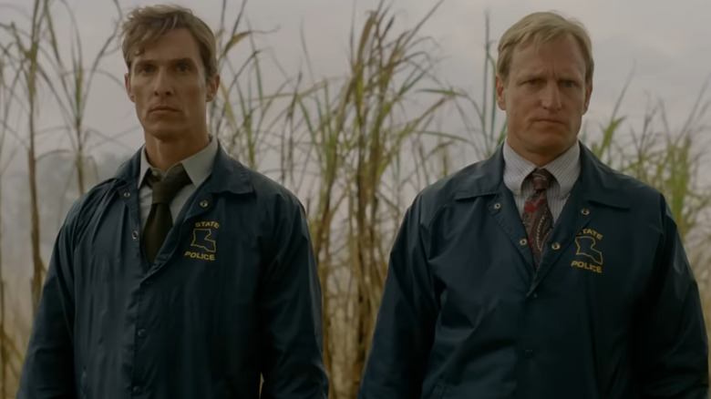 Rust Cohle (Matthew McConaughey) and Marty Hart (Woody Harrelson) stand side by side, their expressions serious and focused in True Detective