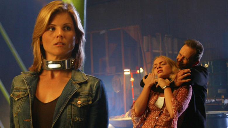Lori Laughlyn as Carolyn Lance, standing near Rachel Skarsten's Dinah Lance, held captive in Birds of Prey.