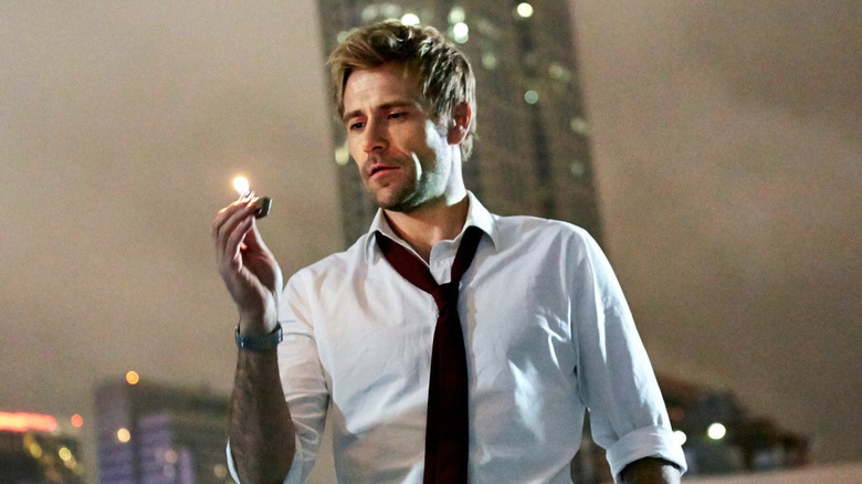 Matt Ryan as John Constantine, looking at a lighter in Constantine.