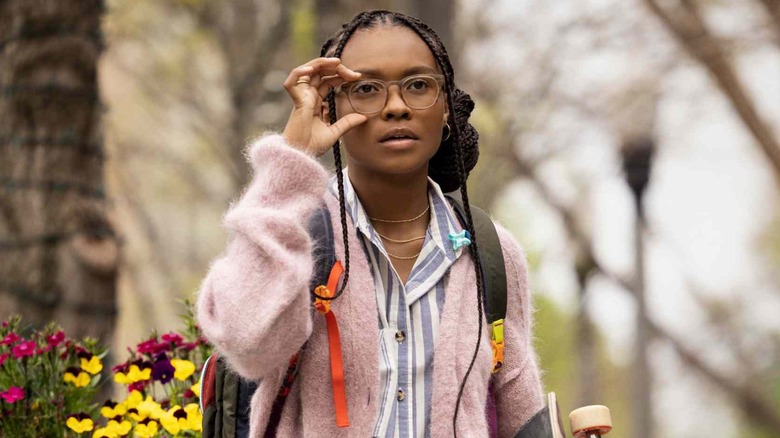 Kaci Walfall as Naomi McDuffie, adjusting her glasses in Naomi.
