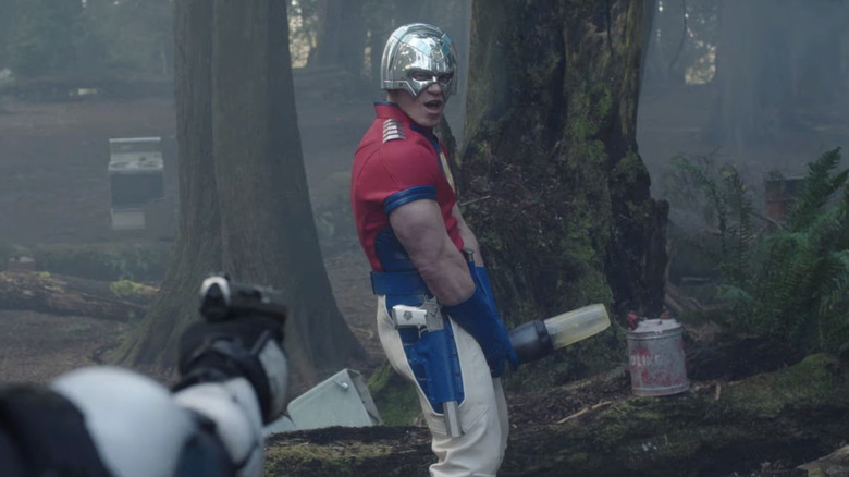 John Cena as Peacemaker, holding a blender as a target in Peacemaker.