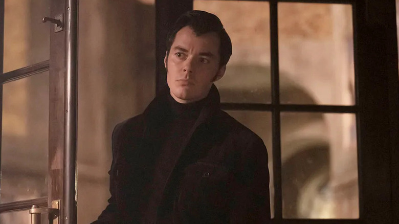 Jack Bannon as Alfred Pennyworth, walking through a door in Pennyworth.