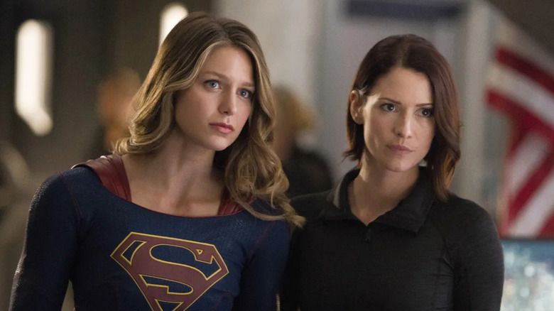 Melissa Benoist as Supergirl and Chyler Leigh as Alex Danvers, standing together in Supergirl.