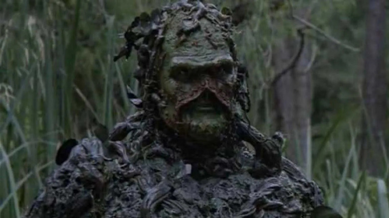 Dick Durock as Swamp Thing, standing in the forest in Swamp Thing.