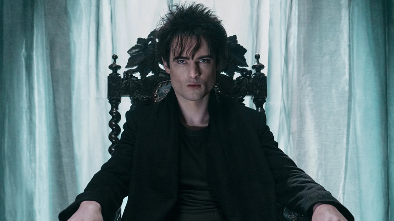 Tom Sturridge as Morpheus, sitting in a chair in The Sandman.
