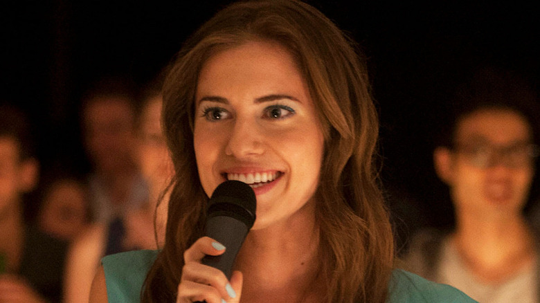 Marnie smiles while speaking into a microphone in the episode 'On All Fours' on Girls