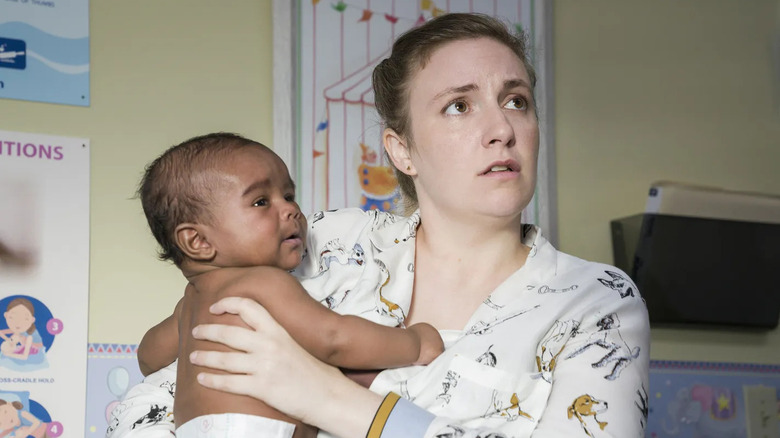 Hannah looking concerned while holding her baby Grover in the series finale of Girls