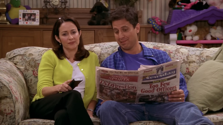 Patricia Heaton as Debra sits next to Ray Romano as Ray in Everybody Loves Raymond