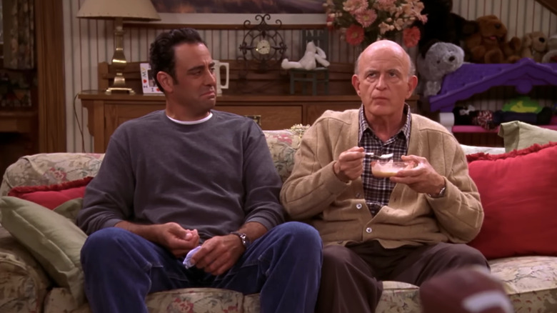 Brad Garrett as Robert looks at Peter Boyle as Frank in Everybody Loves Raymond