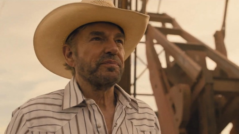 Billy Bob Thornton as Tommy Norris stands in front of an oil pump on Landman