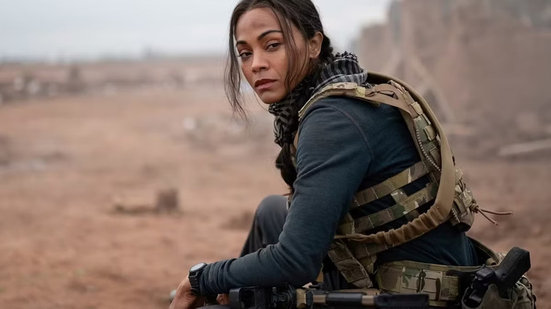 Zoe Saldaña as Joe McNamara sits in a desert on Special Ops: Lioness