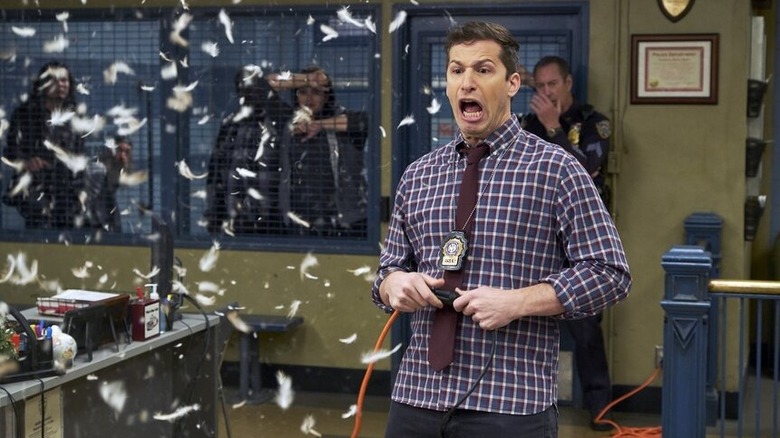 Jake (Andy Samberg) screaming and looking at feathers fly through the air on Brooklyn Nine-Nine