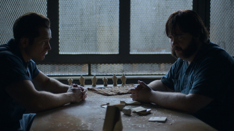 Taron Egerton and Paul Walter Hauser as James "Jimmy" Keene and Larry Hall facing each other in Black Bird