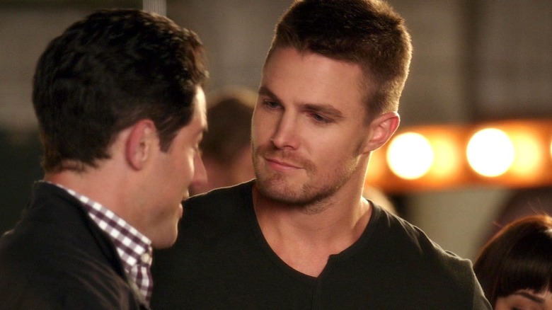 Kyle wearing a black shirt and speaking to Schmidt