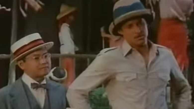 Bruce Boxleitner and Clyde Kusatsu discussing something in an episode of "Bring 'Em Back Alive"