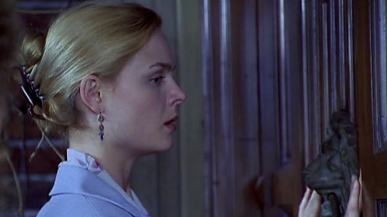 Pam Asbury feels the front door of a mansion in "Rose Red" (2002)