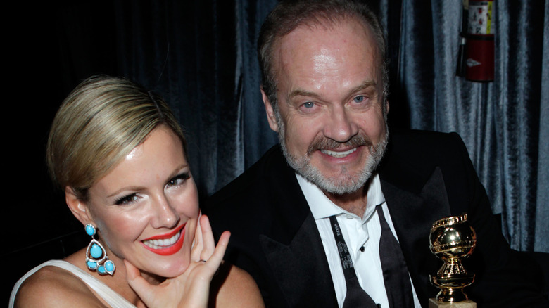 Kathleen Robertson and Kelsey Grammer smiling, Grammer holding Golden Globe